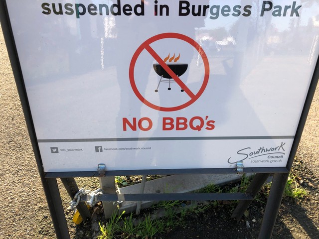 A sign says: &quot;suspended in Burgess Park NO BBQ's&quot;