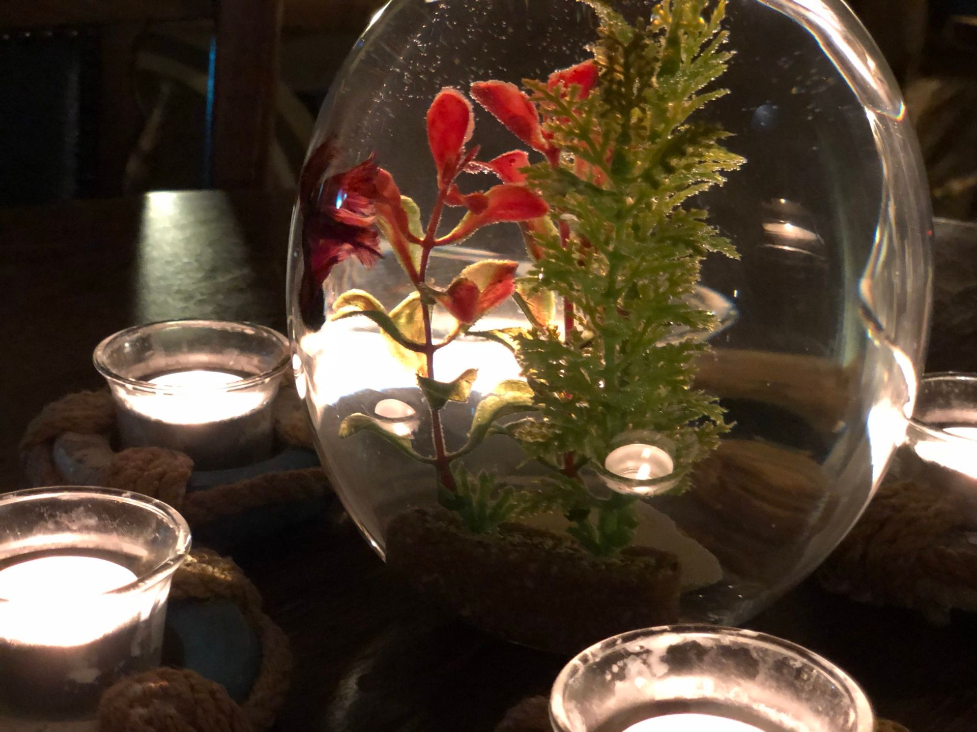 Fish bowl on table with candles